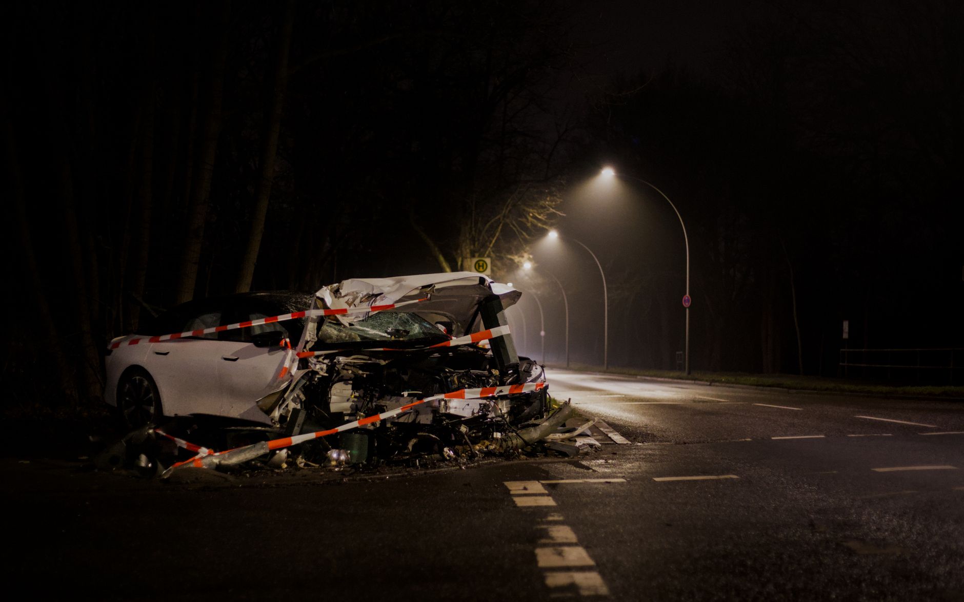 Rozbity samochód po nocnej kolizji na słabo oświetlonej ulicy